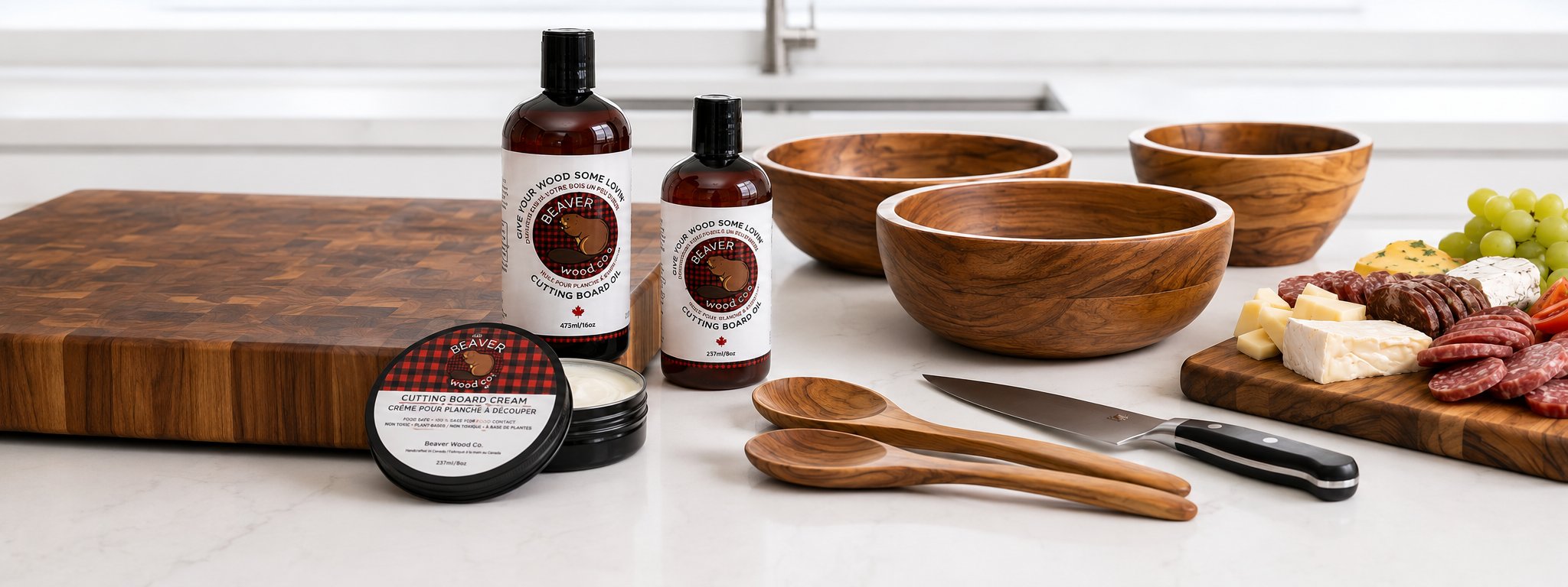 Beaver Wood Care products on a kitchen counter with cutting board, charcuterie, and wooden bowls
